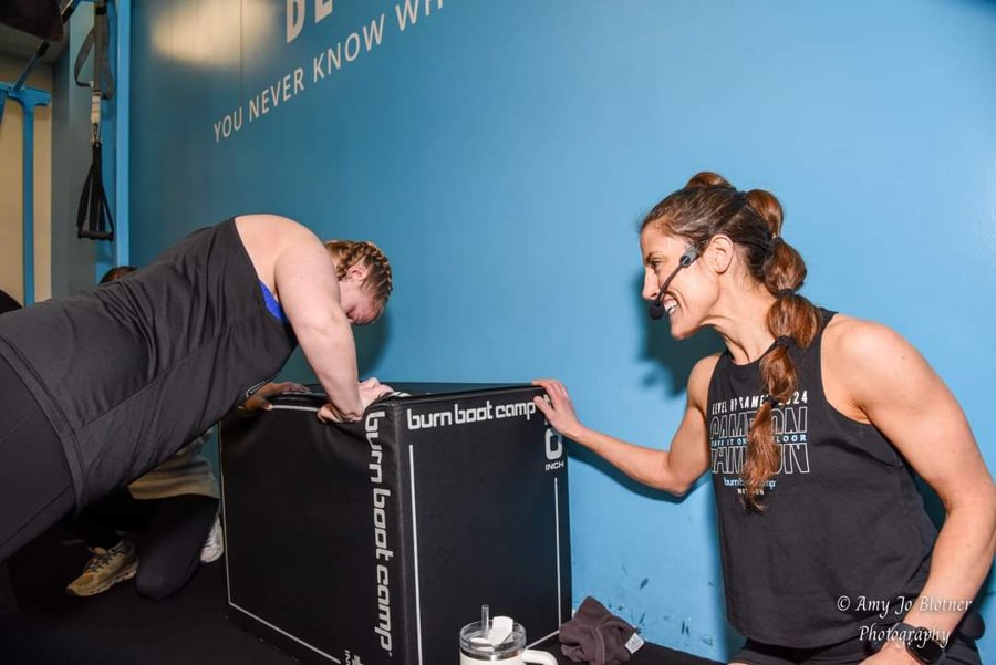 Caitlin coaching a client through box push-ups